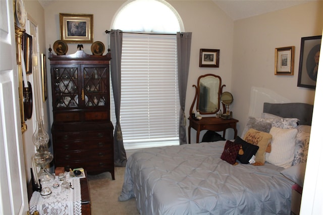 carpeted bedroom featuring lofted ceiling