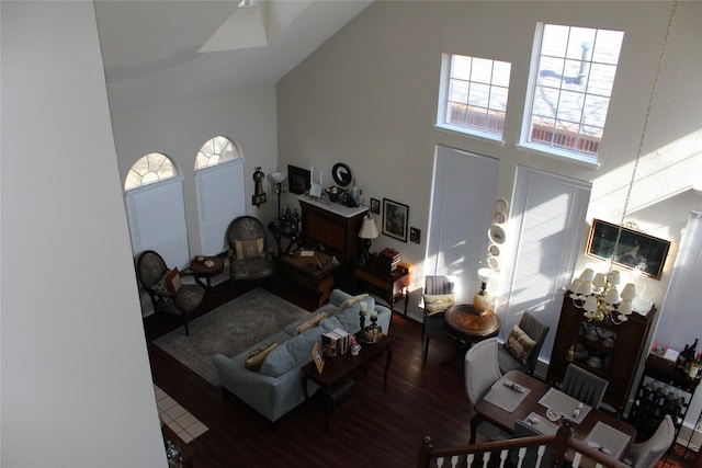 living room with wood-type flooring and high vaulted ceiling