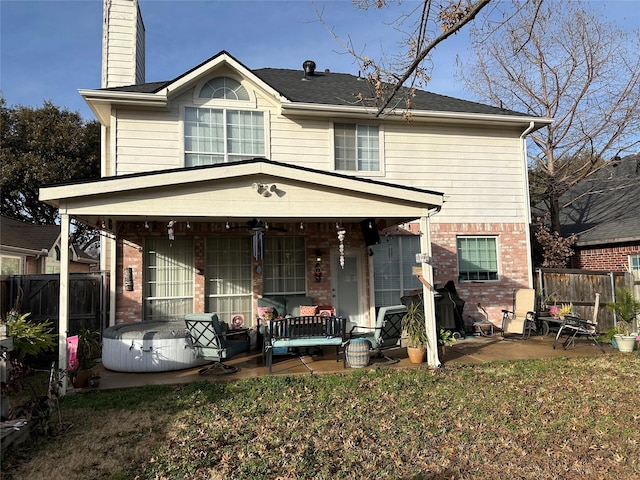 view of front facade with a patio area, a front yard, and a porch