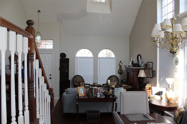 living room with high vaulted ceiling and a notable chandelier