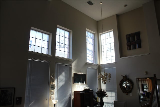 interior space featuring a high ceiling and a notable chandelier