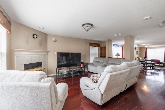 713 Devontree Ct, Fort Worth, TX 76052 - living room with dark wood-type flooring, a fireplace, and visible vents