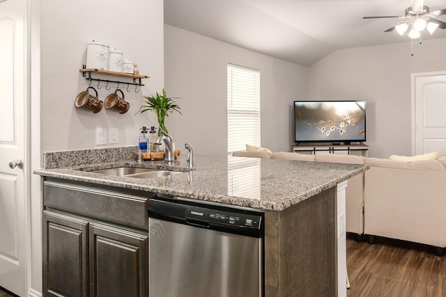 kitchen with lofted ceiling, sink, dark wood-type flooring, dishwasher, and light stone counters