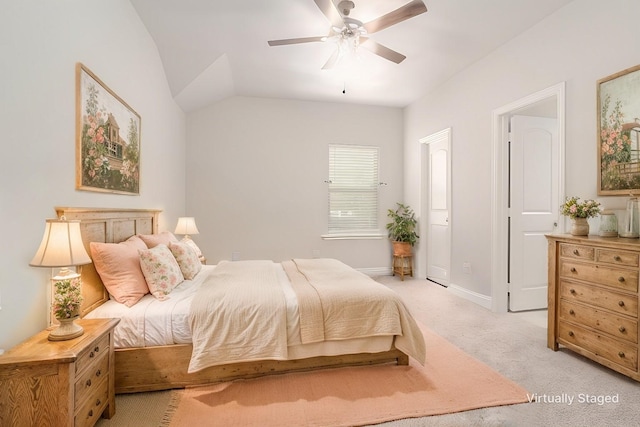 bedroom featuring lofted ceiling, light colored carpet, and ceiling fan