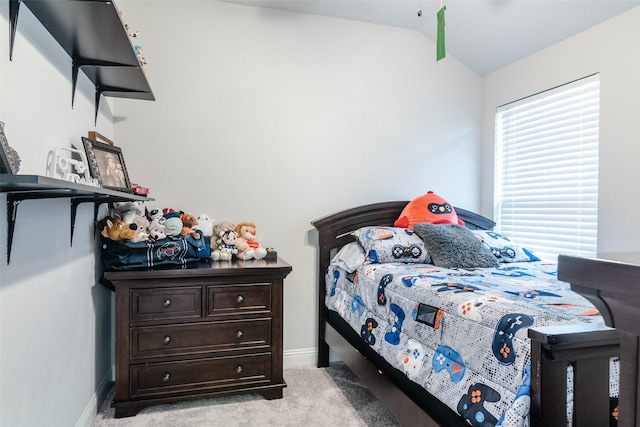 carpeted bedroom with lofted ceiling