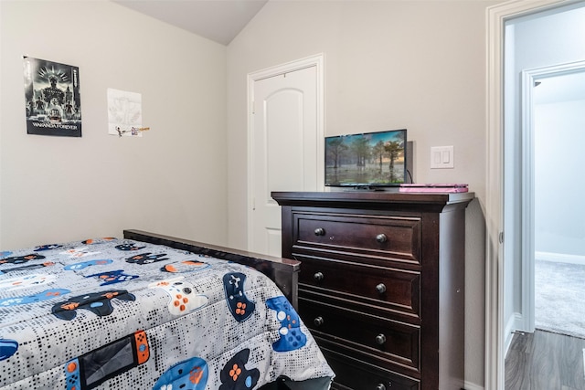 bedroom featuring lofted ceiling and wood-type flooring