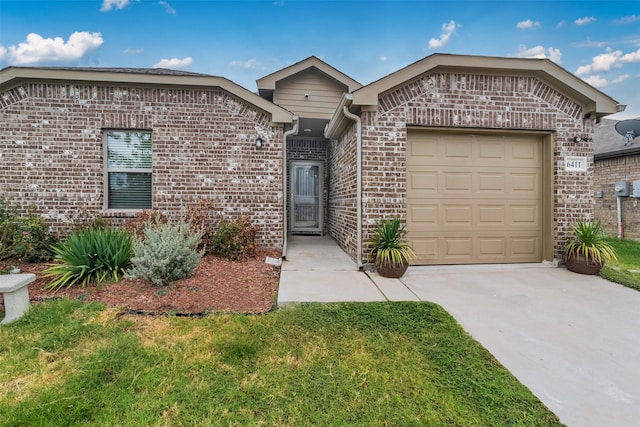 view of front of house with a garage and a front yard