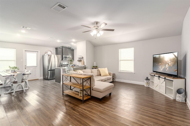 living room featuring lofted ceiling, dark hardwood / wood-style floors, and ceiling fan