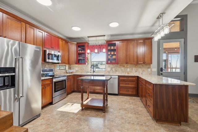 kitchen with pendant lighting, light stone countertops, decorative backsplash, and stainless steel appliances