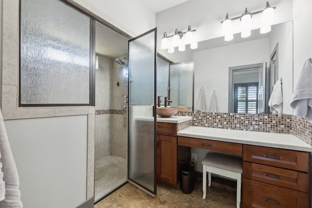 bathroom with tasteful backsplash, vanity, and tiled shower