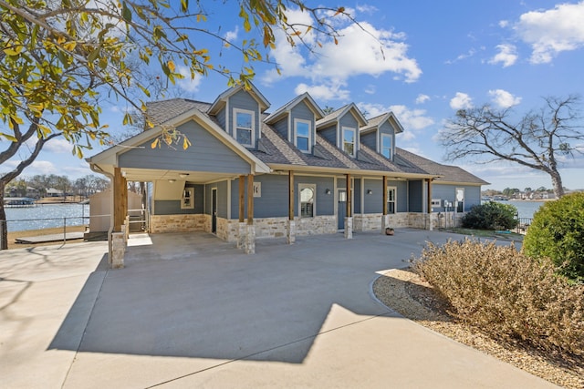 view of front of home with a carport and a water view