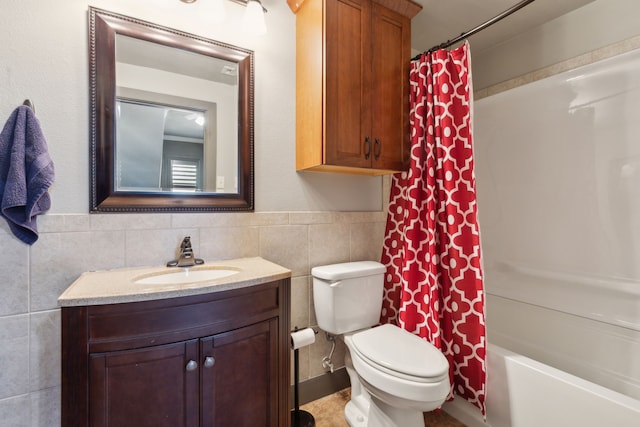 full bathroom featuring shower / bath combination with curtain, vanity, toilet, and tile walls