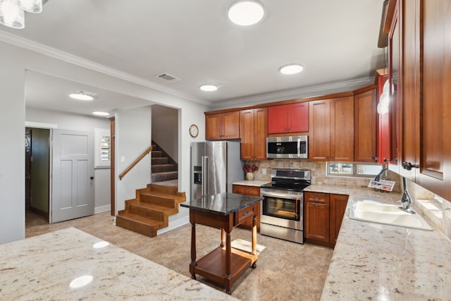 kitchen featuring stainless steel appliances, sink, and light stone counters