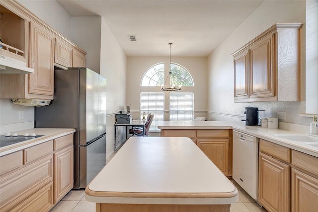 kitchen featuring white dishwasher, a center island, hanging light fixtures, and light brown cabinetry