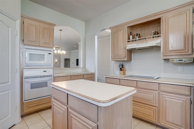 kitchen with light tile patterned flooring, decorative light fixtures, a center island, light brown cabinets, and white appliances