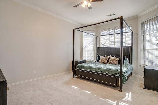 carpeted bedroom featuring ornamental molding and ceiling fan