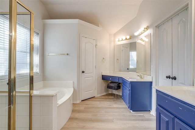 bathroom with lofted ceiling, hardwood / wood-style floors, vanity, and plus walk in shower