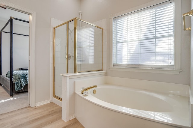 bathroom with separate shower and tub and hardwood / wood-style floors