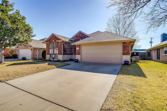 ranch-style house featuring a garage, a front yard, and cooling unit