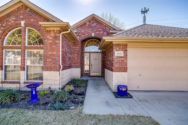 view of exterior entry with a garage