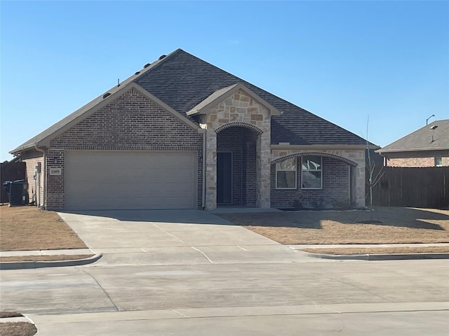 view of front of home with cooling unit and a garage