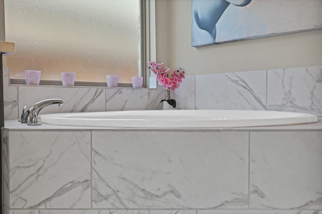 bathroom with tiled bath