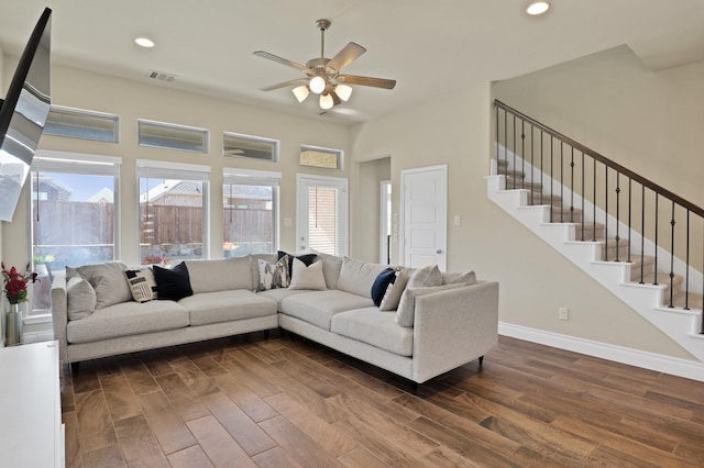 living room with ceiling fan and dark hardwood / wood-style flooring