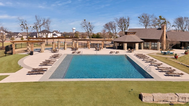 view of pool with a lawn, a patio area, and a pergola