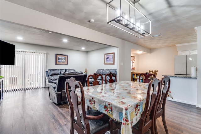 dining room with dark hardwood / wood-style flooring