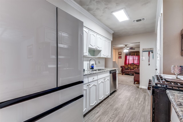 kitchen with white cabinetry, appliances with stainless steel finishes, light stone counters, and light hardwood / wood-style floors