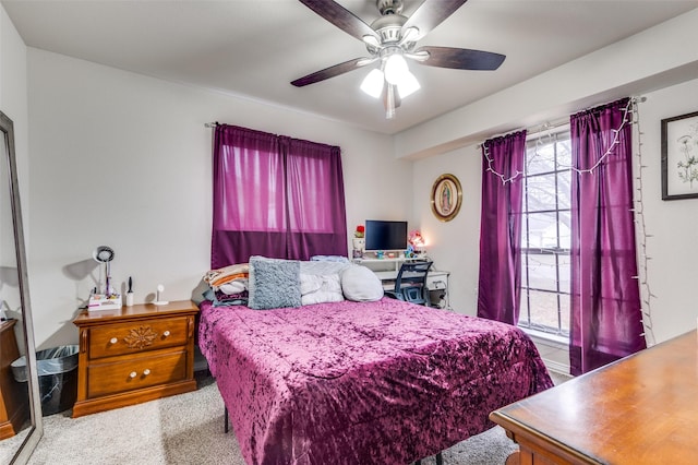 bedroom featuring multiple windows, light colored carpet, and ceiling fan