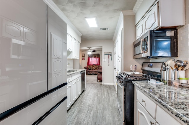 kitchen featuring white cabinetry, ornamental molding, stainless steel appliances, and light wood-type flooring