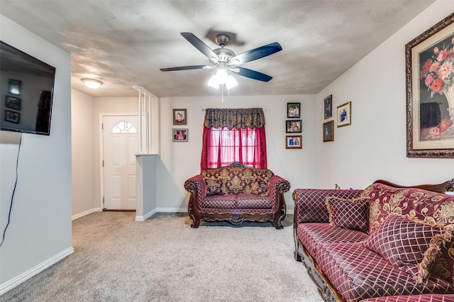 carpeted living room featuring ceiling fan