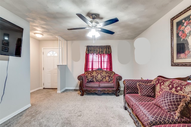 carpeted living room with ceiling fan