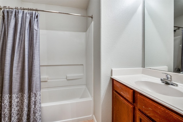 bathroom featuring vanity and shower / bathtub combination with curtain