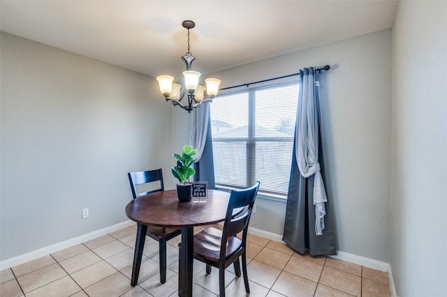 dining area featuring a chandelier and light tile patterned flooring