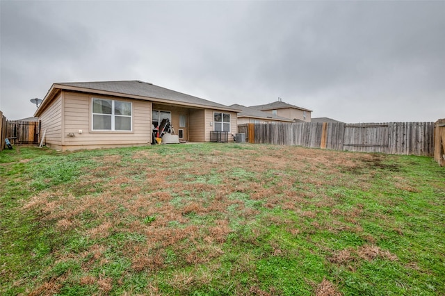 rear view of property with a lawn