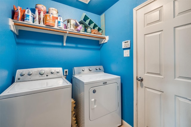 washroom with independent washer and dryer