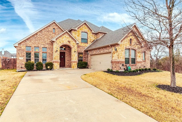 view of front facade featuring driveway, a front lawn, and brick siding