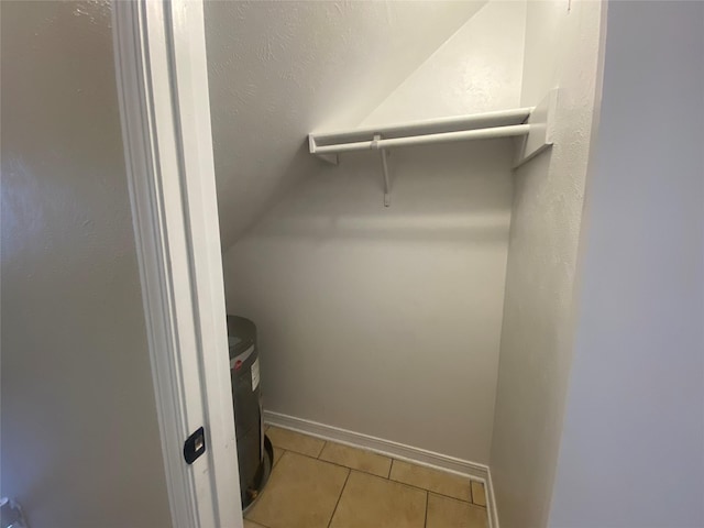 spacious closet with tile patterned flooring and vaulted ceiling