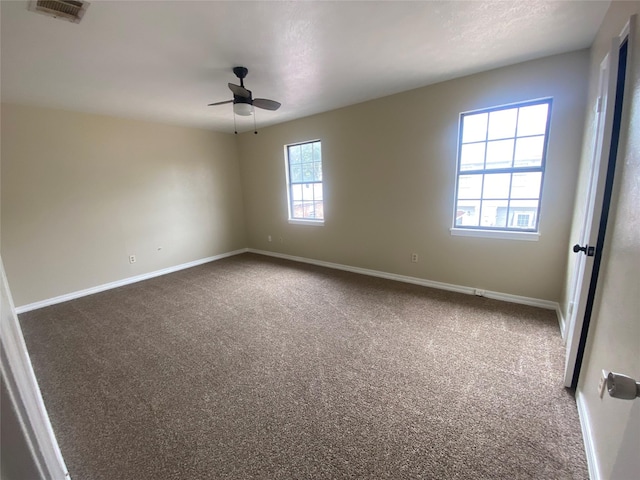 empty room featuring ceiling fan and carpet flooring