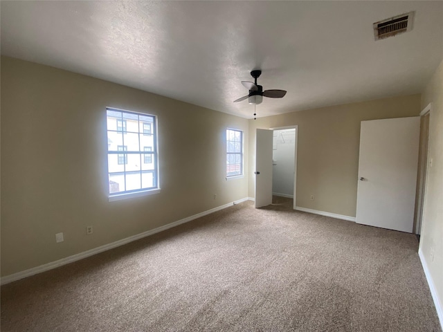 unfurnished bedroom with ceiling fan and carpet flooring