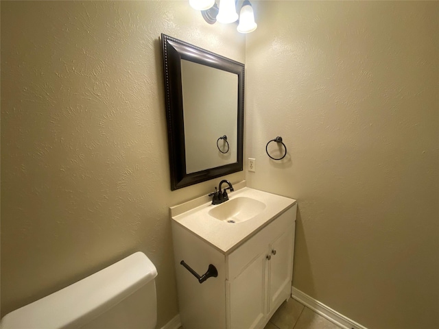 bathroom featuring tile patterned floors, vanity, and toilet