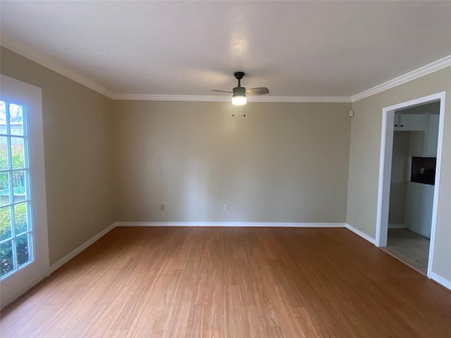 spare room with wood-type flooring, ornamental molding, and ceiling fan