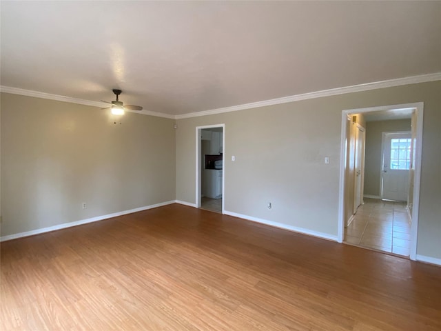 empty room featuring crown molding, ceiling fan, and light wood-type flooring