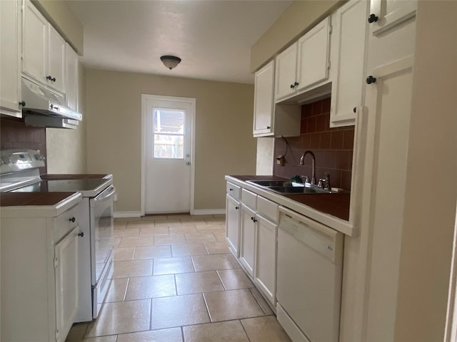 kitchen with sink, white appliances, white cabinetry, light tile patterned flooring, and decorative backsplash