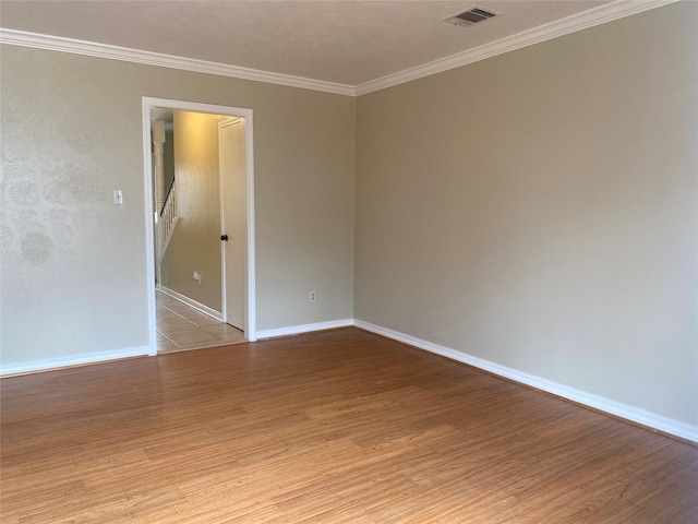 unfurnished room with ornamental molding and light hardwood / wood-style flooring