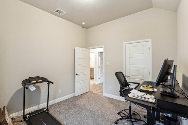 office space featuring vaulted ceiling and carpet