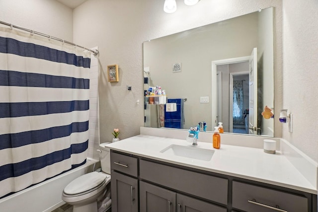 full bathroom with vanity, shower / bath combo with shower curtain, and toilet