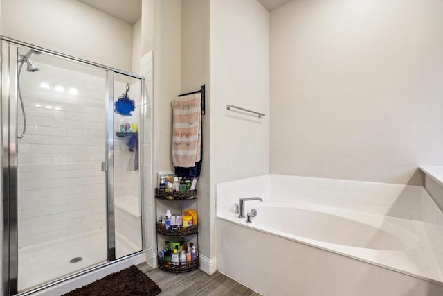 bathroom featuring hardwood / wood-style flooring and independent shower and bath